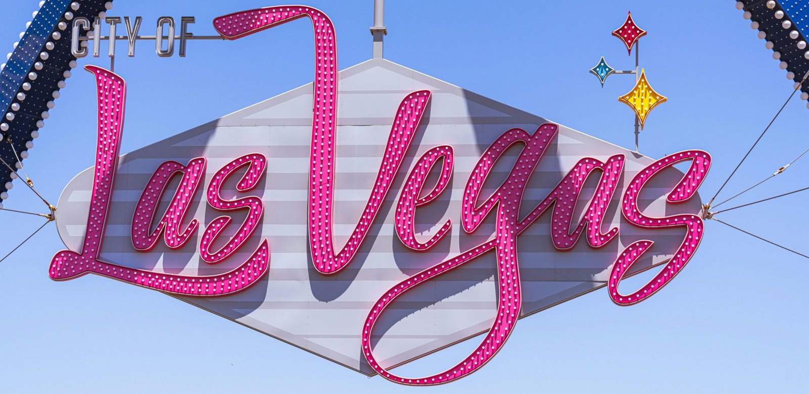 The famous Las Vegas sign with vibrant colors against a clear sky, a must-see landmark.